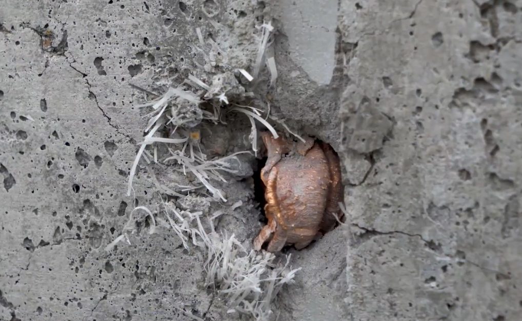 A .50 caliber round tested against an Amidon Shield wall; the wall remains intact.
