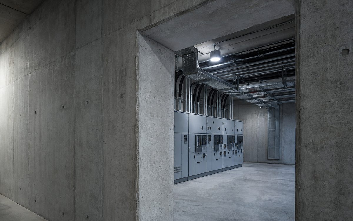 Switchgear and cable trays inside a hardened concrete utility building